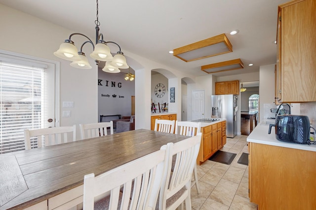 dining area with a chandelier and sink