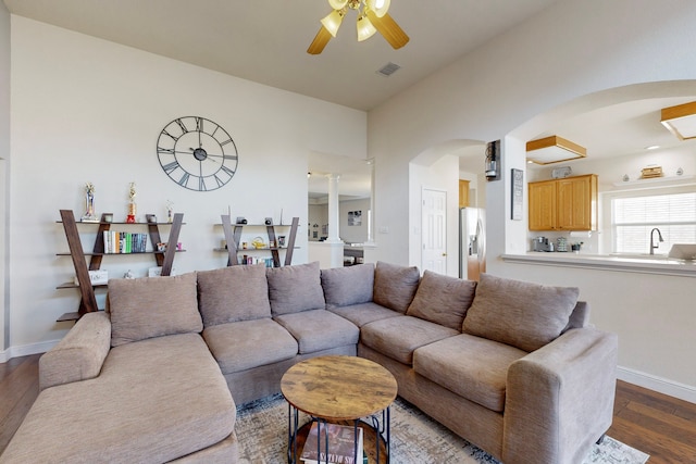 living room featuring hardwood / wood-style floors and ceiling fan