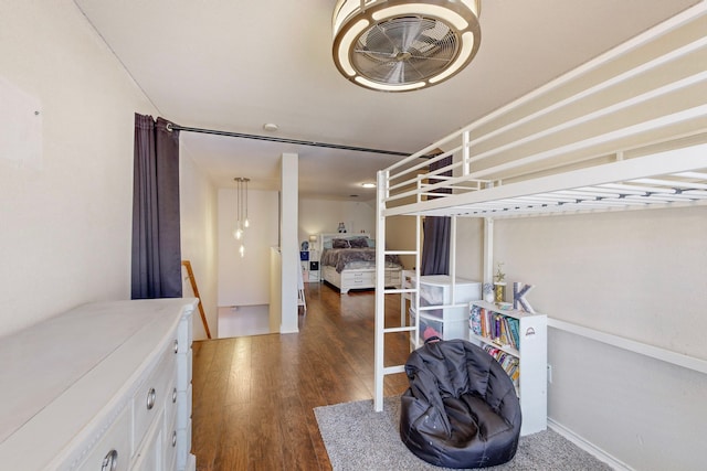 bedroom with dark hardwood / wood-style flooring