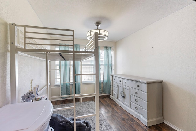 bedroom with dark hardwood / wood-style floors