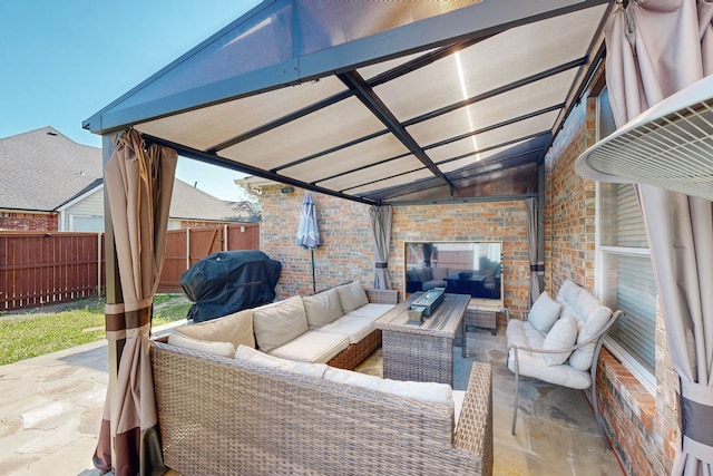 view of patio featuring a gazebo, area for grilling, and an outdoor hangout area