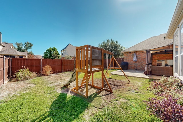 view of play area with a patio area and a lawn