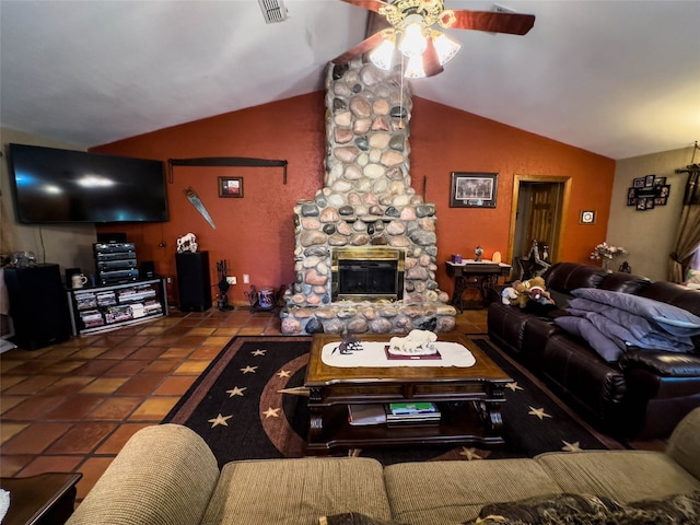 living room with tile flooring, ceiling fan, vaulted ceiling, and a fireplace