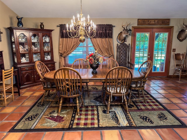 tiled dining area featuring french doors and an inviting chandelier