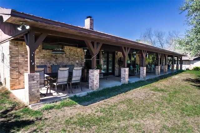 view of nearby features featuring a patio area, exterior bar, and a lawn