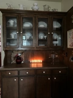 bar featuring dark brown cabinets