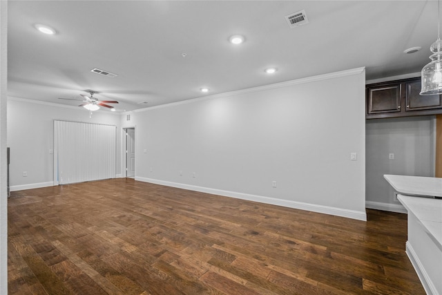 unfurnished living room featuring crown molding, dark wood-type flooring, and ceiling fan