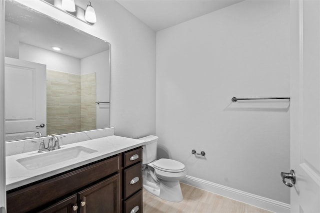 bathroom with vanity, a shower, and toilet