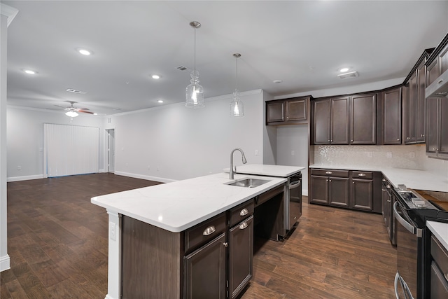 kitchen with electric stove, sink, decorative backsplash, a center island with sink, and decorative light fixtures