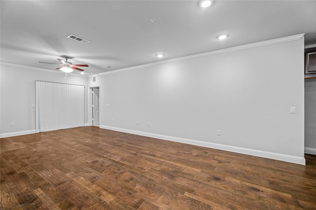 spare room with dark wood-type flooring and ornamental molding