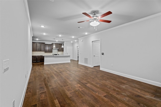 unfurnished living room with crown molding, dark hardwood / wood-style floors, and ceiling fan