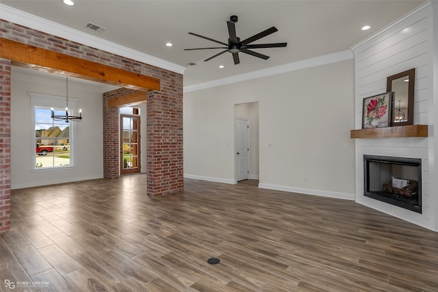 unfurnished living room with dark hardwood / wood-style flooring, ornamental molding, and a fireplace