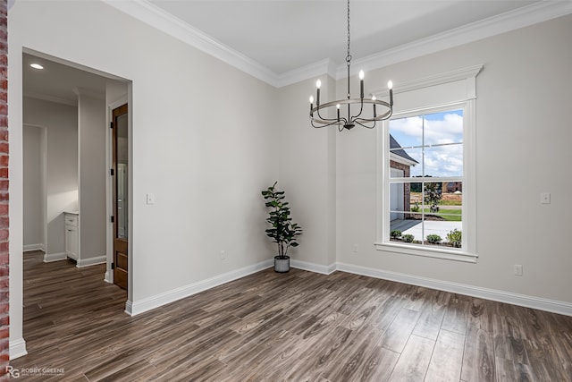 unfurnished dining area featuring dark wood-type flooring, a chandelier, and ornamental molding