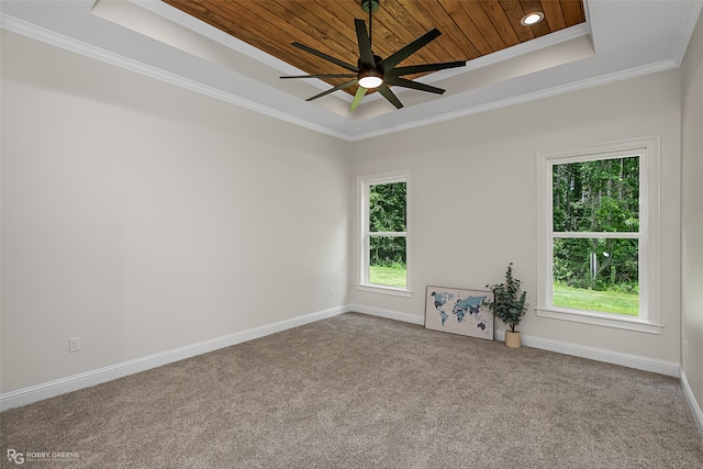 spare room with carpet floors, wooden ceiling, ornamental molding, ceiling fan, and a raised ceiling