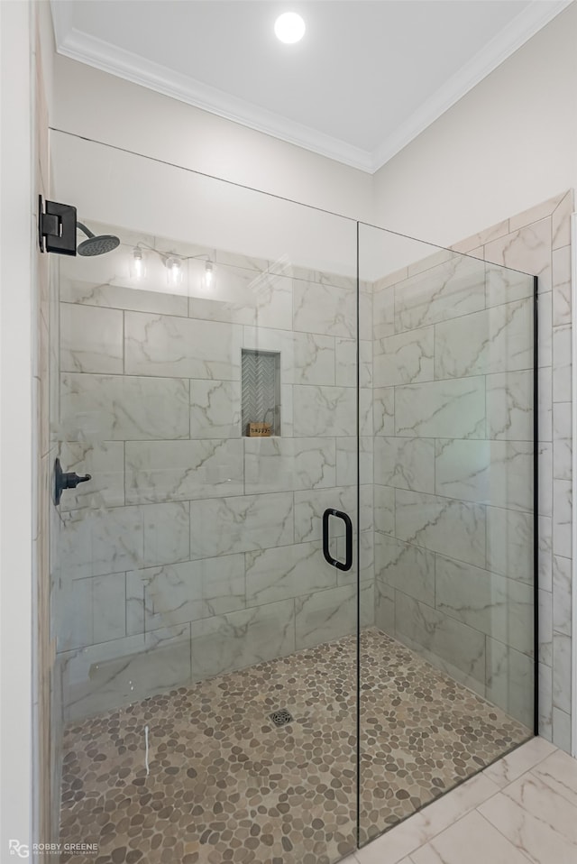 bathroom with ornamental molding and walk in shower