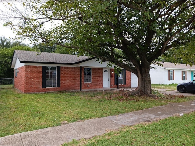 single story home featuring a garage and a front lawn