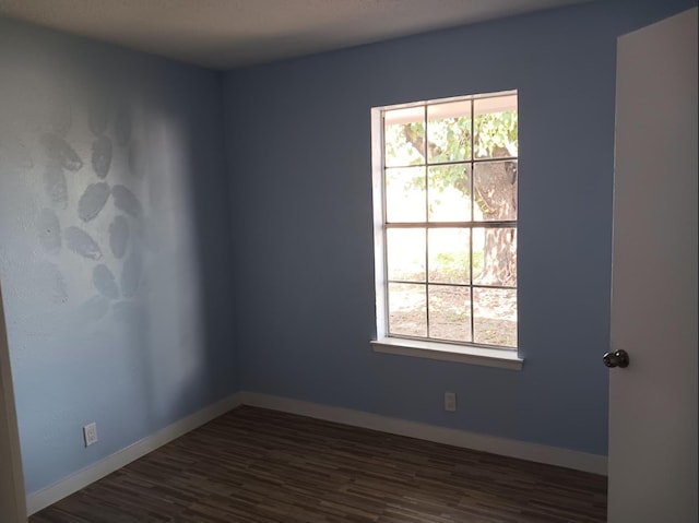 empty room with dark hardwood / wood-style floors