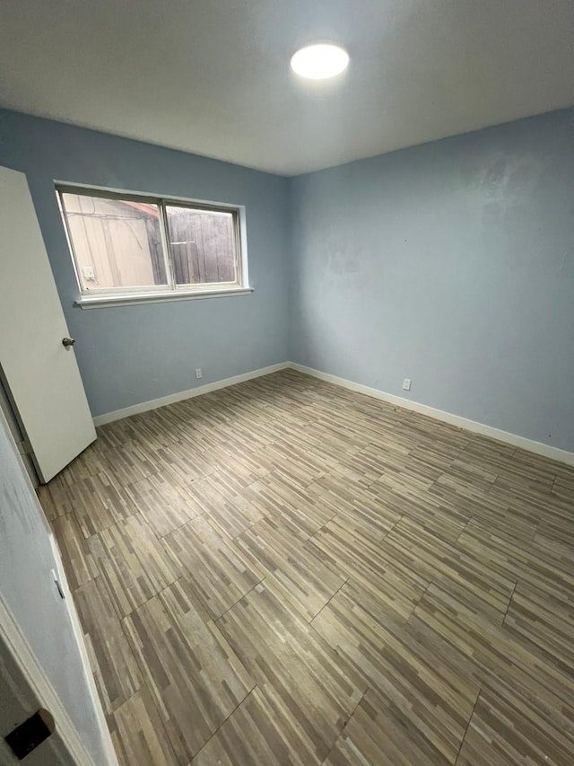 spare room featuring hardwood / wood-style floors