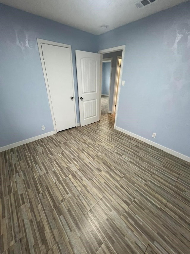 unfurnished bedroom featuring hardwood / wood-style floors