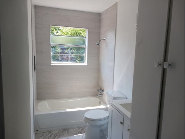 full bathroom featuring tiled shower / bath combo, vanity, and toilet