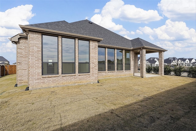 rear view of property featuring a patio area and a yard