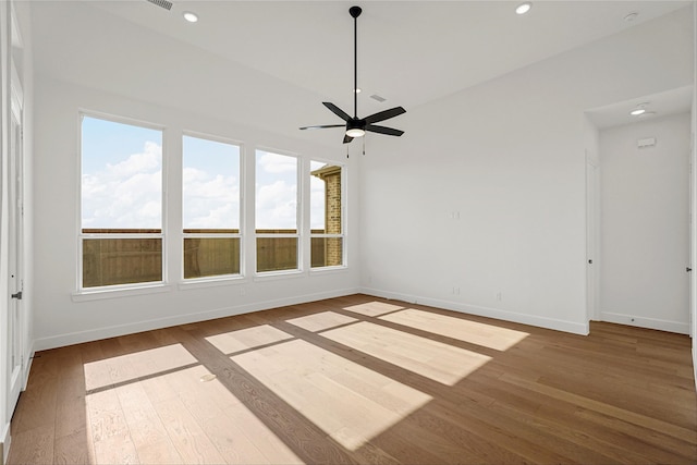 empty room featuring hardwood / wood-style floors and ceiling fan