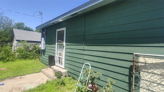 view of side of home with a lawn