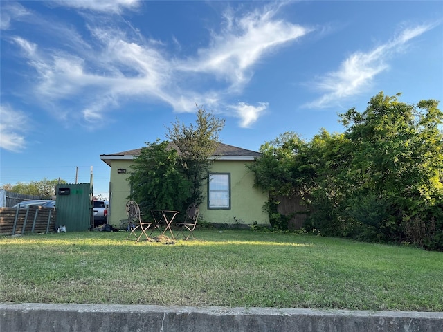 view of side of home featuring a lawn