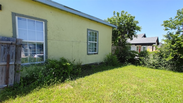 view of property exterior featuring a lawn