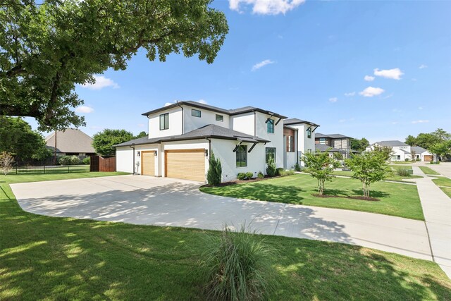 view of front of home with a garage and a front yard