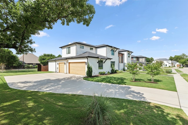 view of front of house featuring a garage and a front lawn