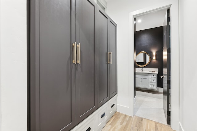 mudroom featuring sink and light hardwood / wood-style flooring