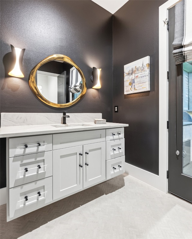 bathroom featuring parquet floors and vanity