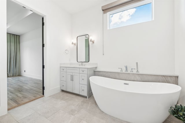 bathroom with vanity, a bathtub, and tile patterned floors