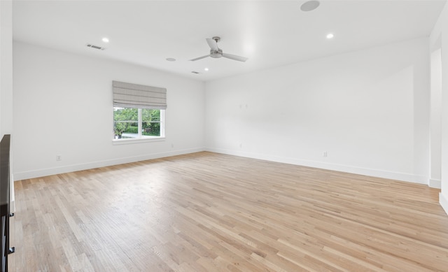 spare room with ceiling fan and light wood-type flooring