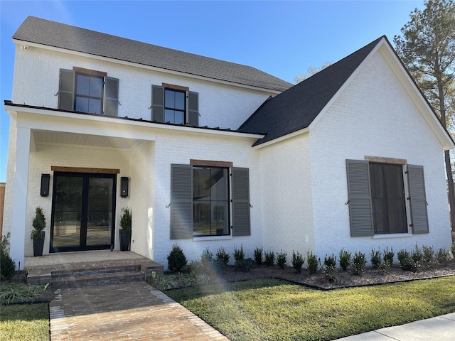 view of front of property with brick siding and a front lawn