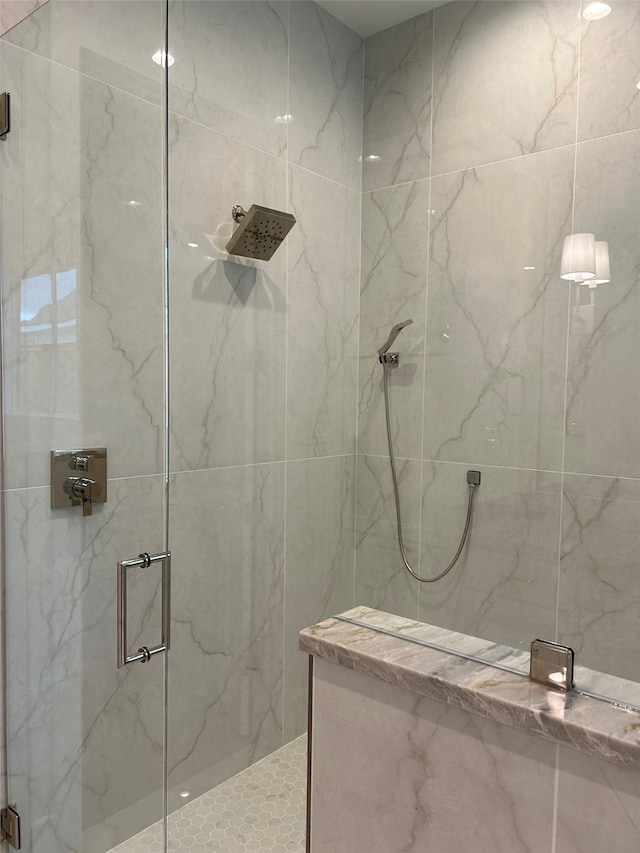 bathroom featuring a shower with door