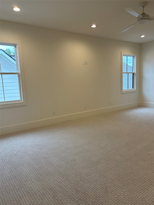 unfurnished room featuring light colored carpet and ceiling fan