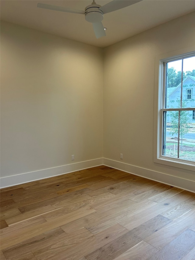 empty room with light hardwood / wood-style flooring and ceiling fan