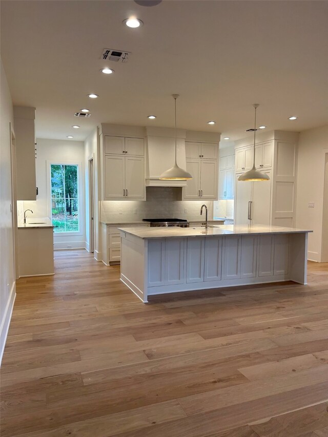 unfurnished dining area with light hardwood / wood-style floors and an inviting chandelier