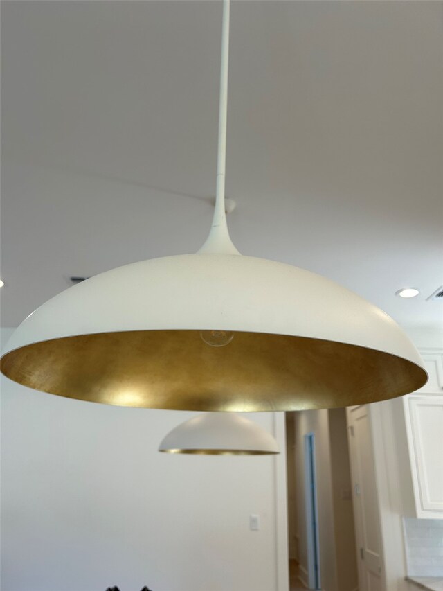 kitchen featuring white cabinets, pendant lighting, built in fridge, and custom exhaust hood