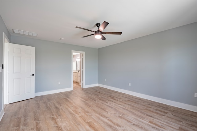 unfurnished bedroom with ensuite bath, ceiling fan, and light wood-type flooring