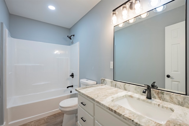 full bathroom featuring hardwood / wood-style flooring, vanity, toilet, and bathing tub / shower combination