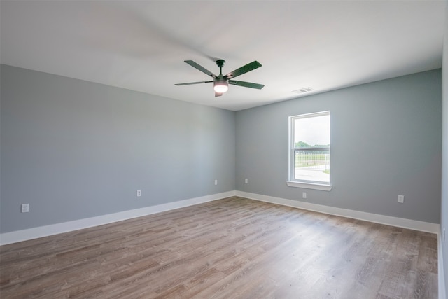 spare room with ceiling fan and light hardwood / wood-style flooring