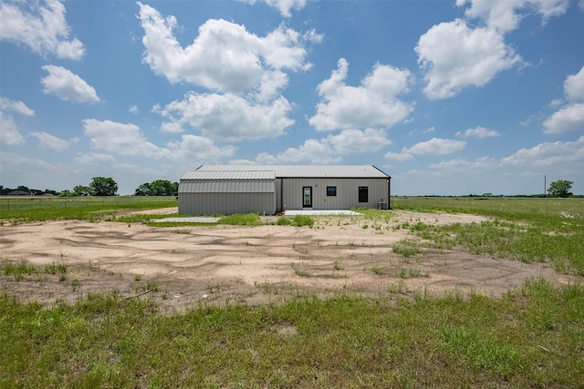 view of outdoor structure with a rural view