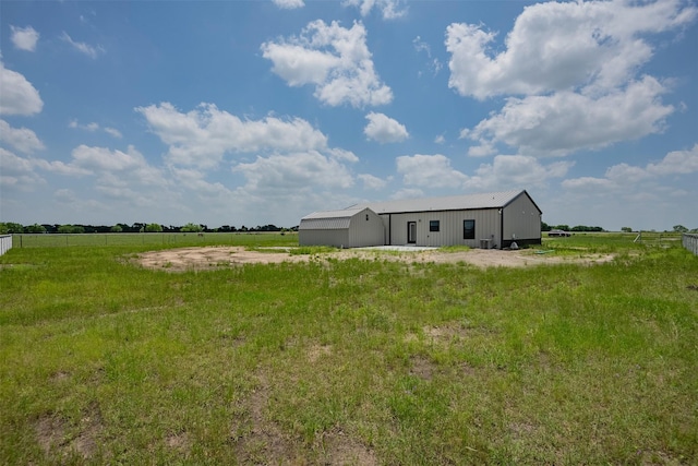 view of yard with a rural view and an outdoor structure