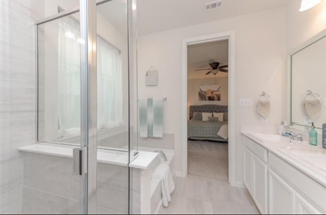 bathroom featuring vanity, ceiling fan, walk in shower, and tile patterned flooring