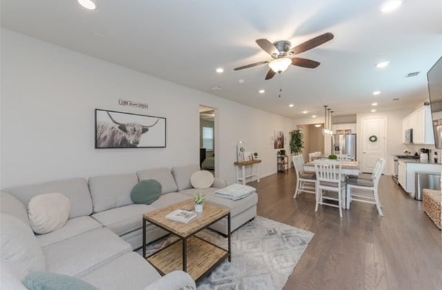 living room with hardwood / wood-style flooring and ceiling fan