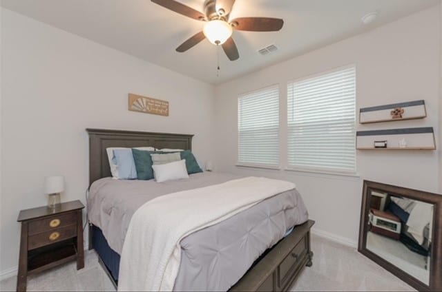 bedroom with light colored carpet and ceiling fan