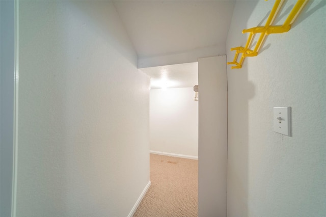 hallway featuring light colored carpet